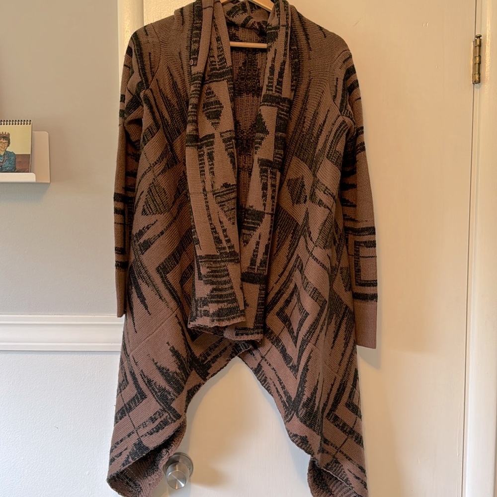 Aztec print sweater/wrap. Has a button to close one side across